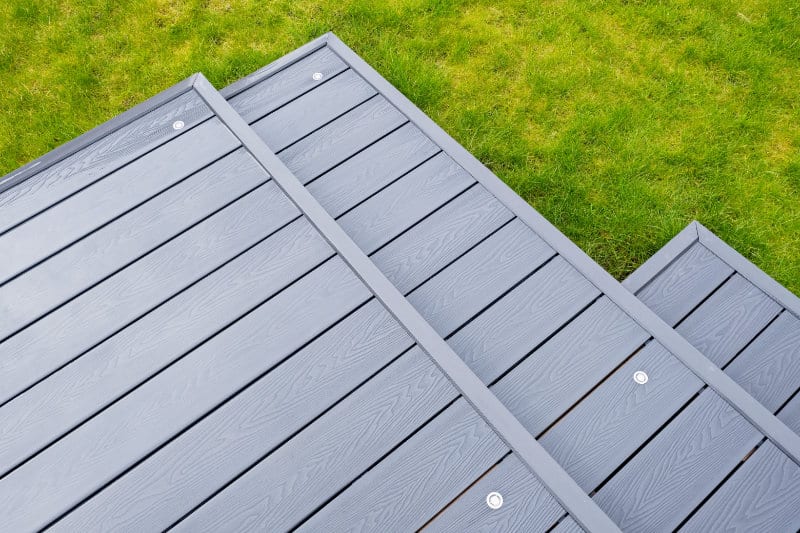 Ash grey composite decking on a rainy wet day showing the full grain of the decking boards A good background image